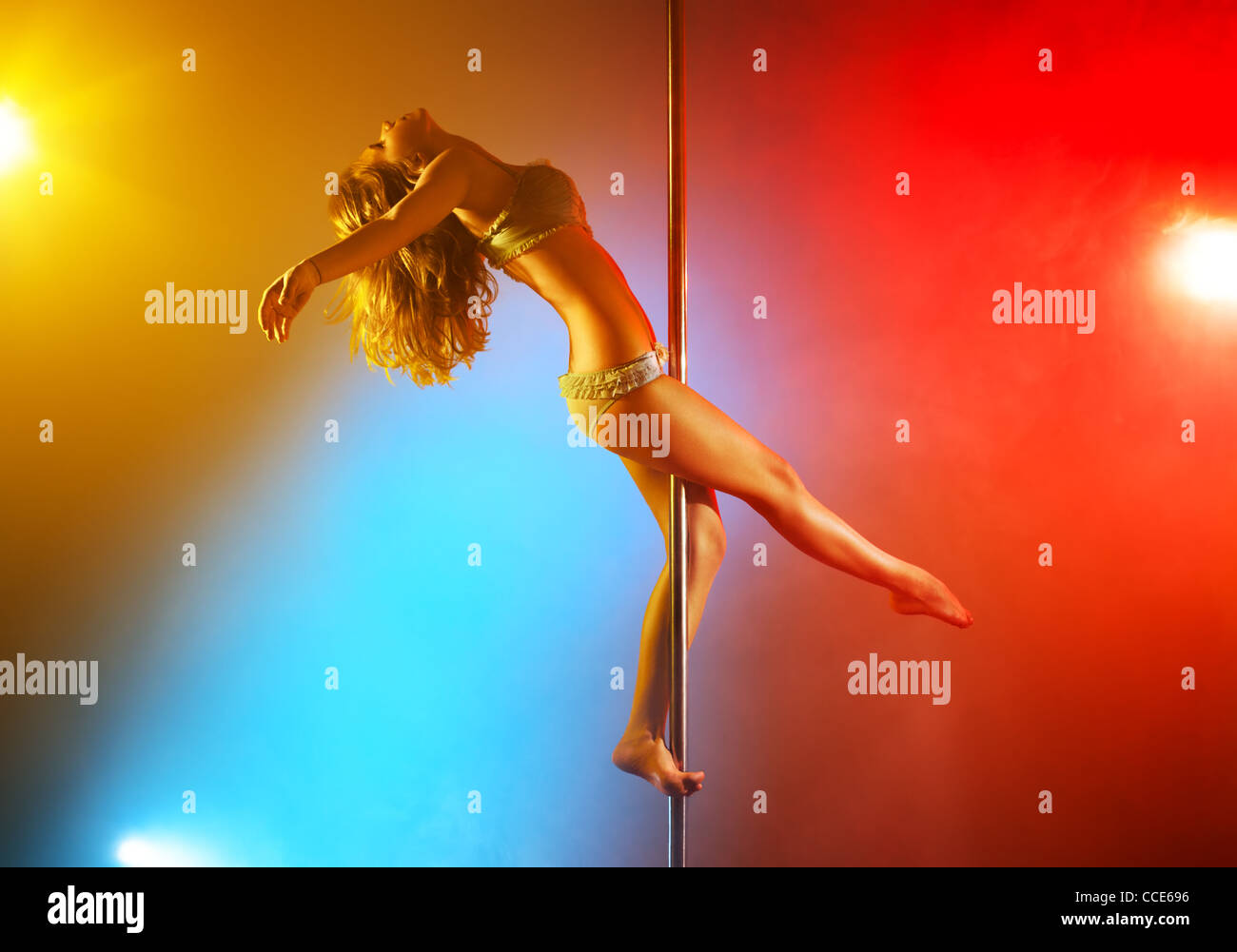 Young pole dance woman with colored lights. Stock Photo