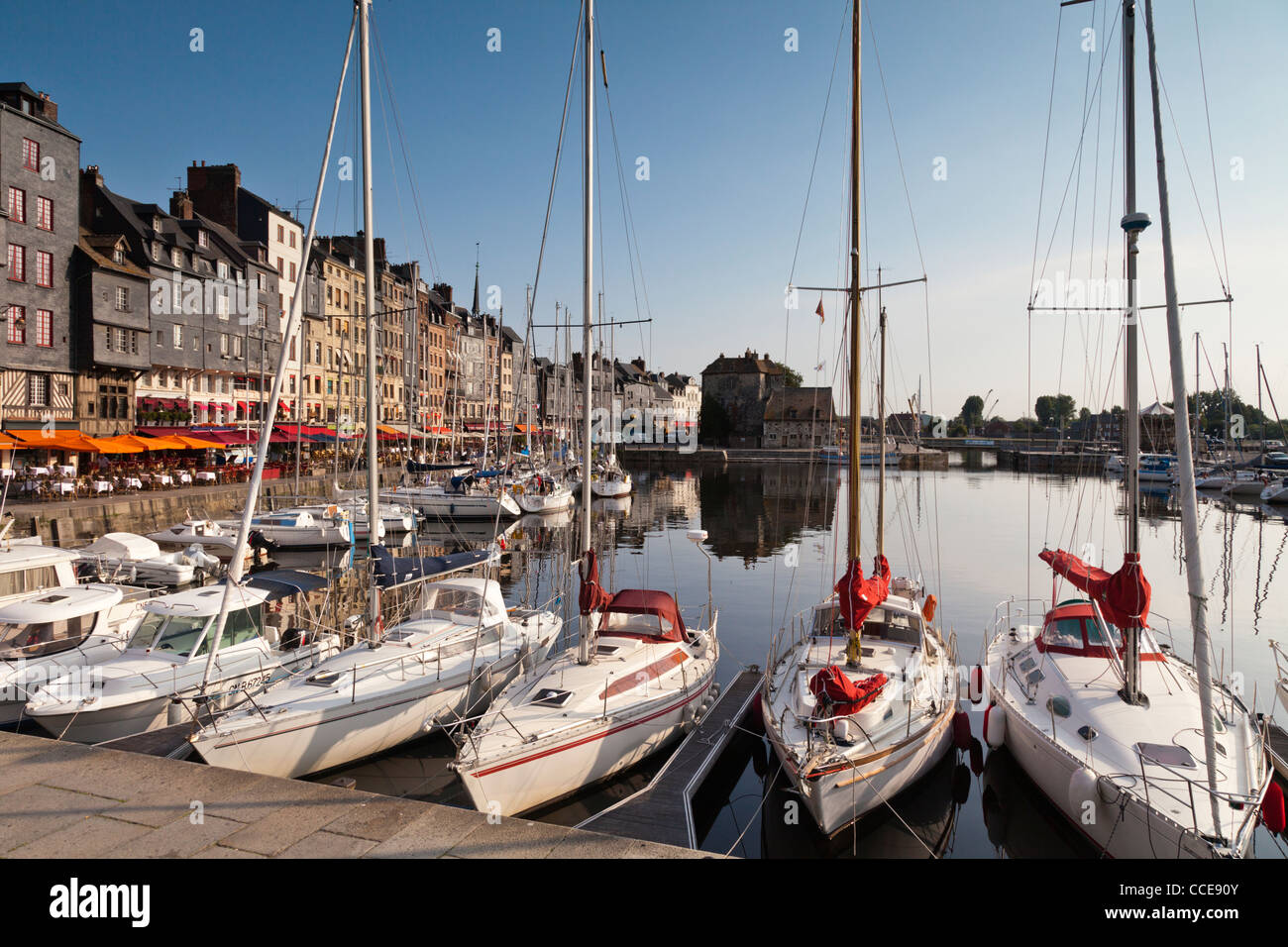 Sailing and power boats line the old harbour basin of Honfleur in Normandy, France. Stock Photo