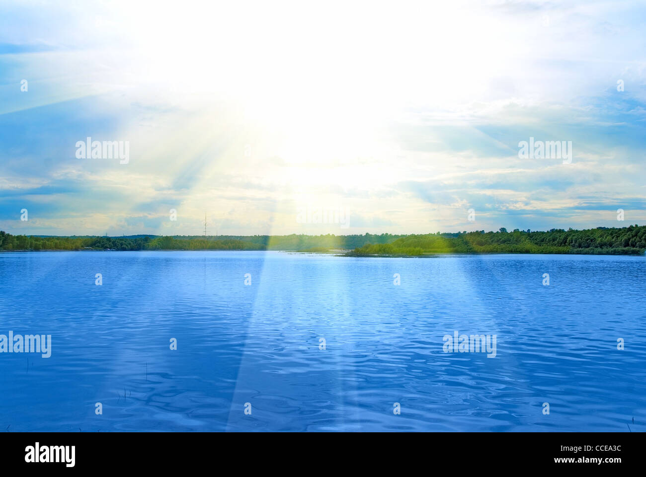 Lake, green field, sun and blue sky Stock Photo - Alamy
