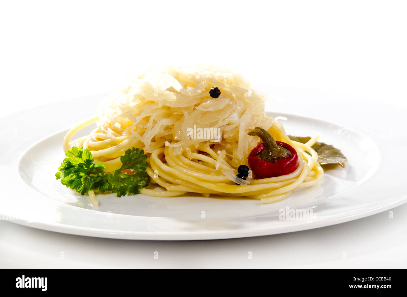 Sauerkraut with spaghetti and red pepper on a white plate Stock Photo