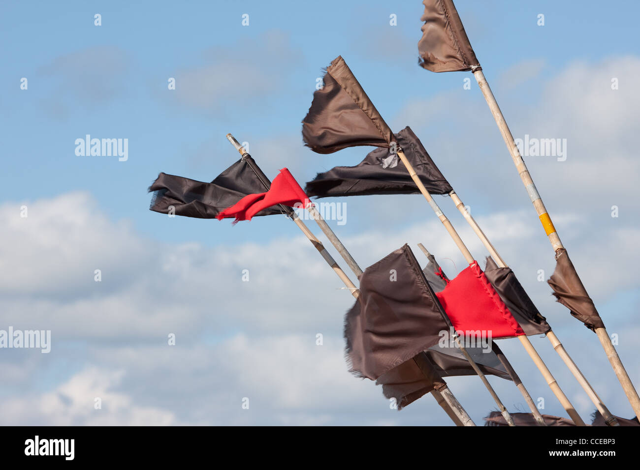 Fishermen flags against a blue sky. Stock Photo
