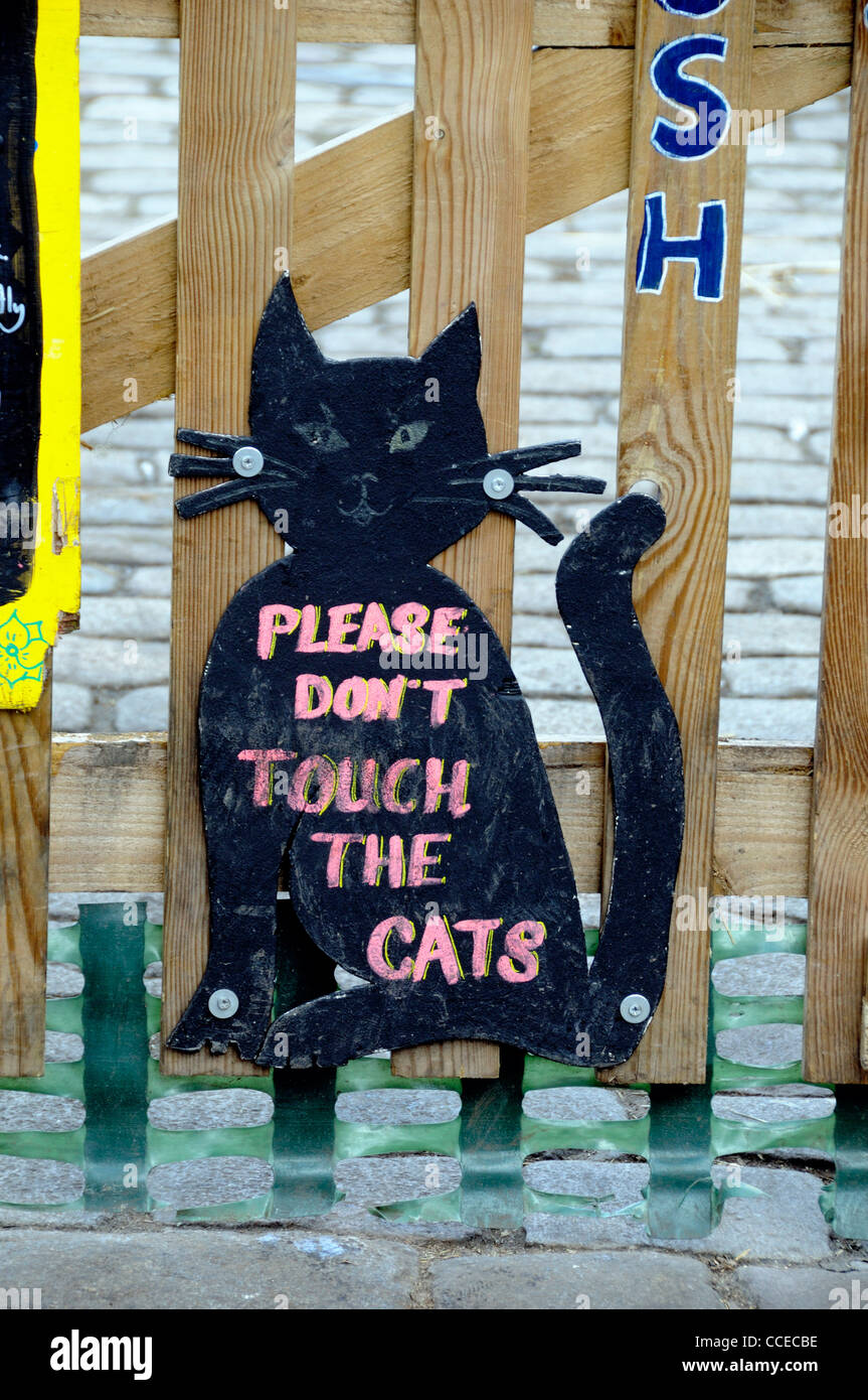Black cat shaped sign saying Please Don't Touch the Cats, Hackney City Farm London England UK Stock Photo