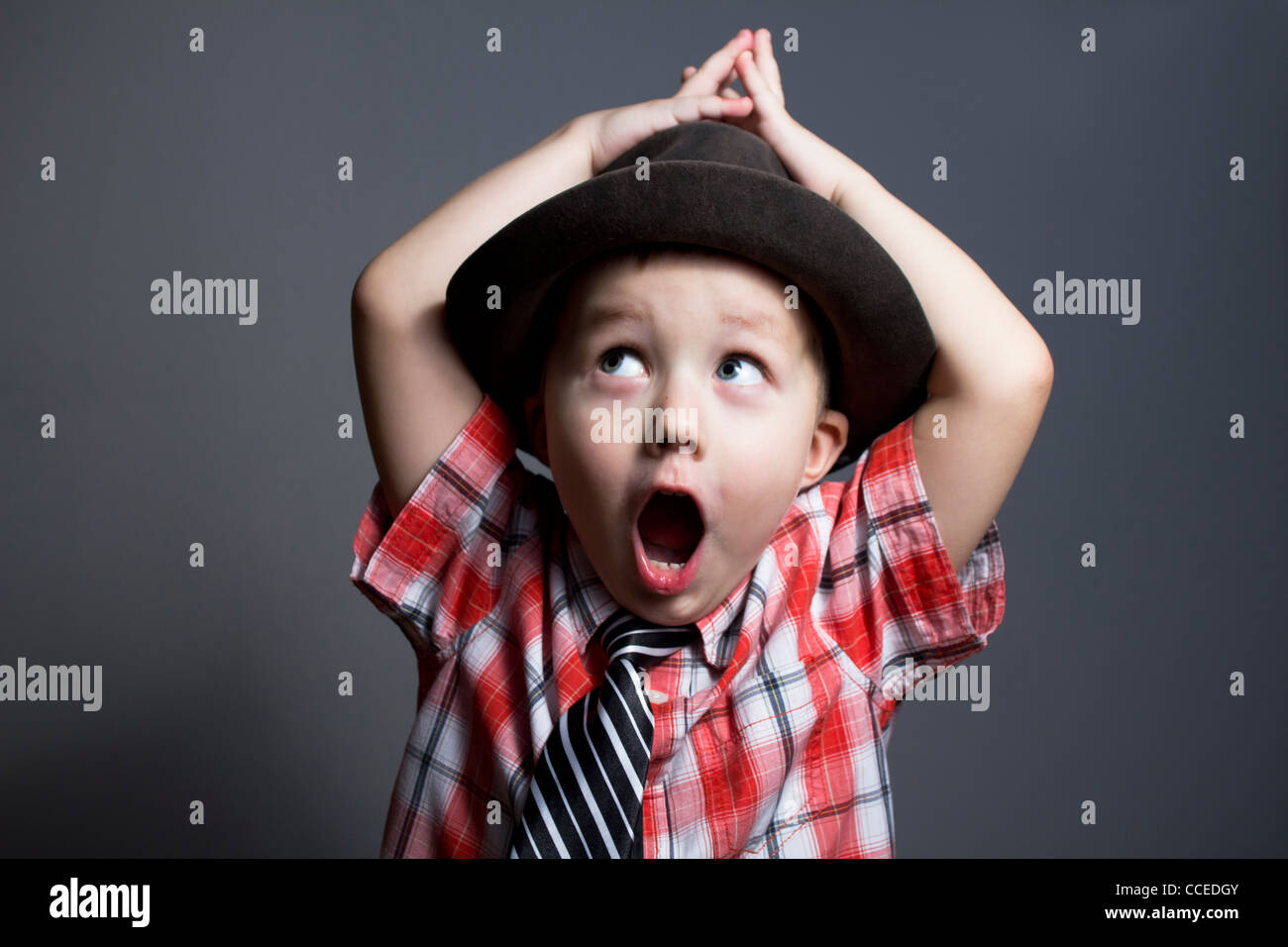 The boy in a hat on a gray background Stock Photo