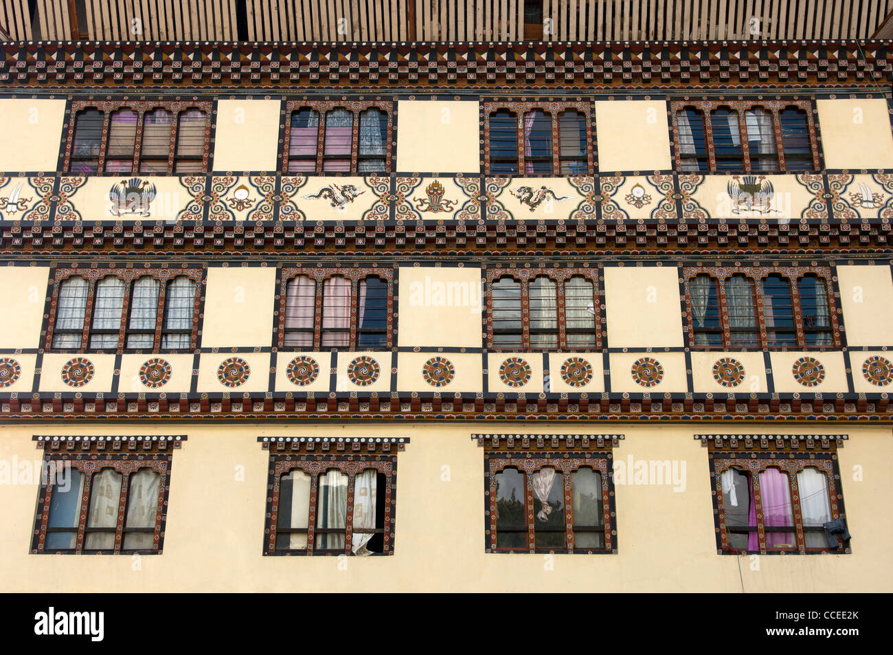 Traditional front with ornate windows of a commercial building in the centre of Thimphu, Bhutan Stock Photo