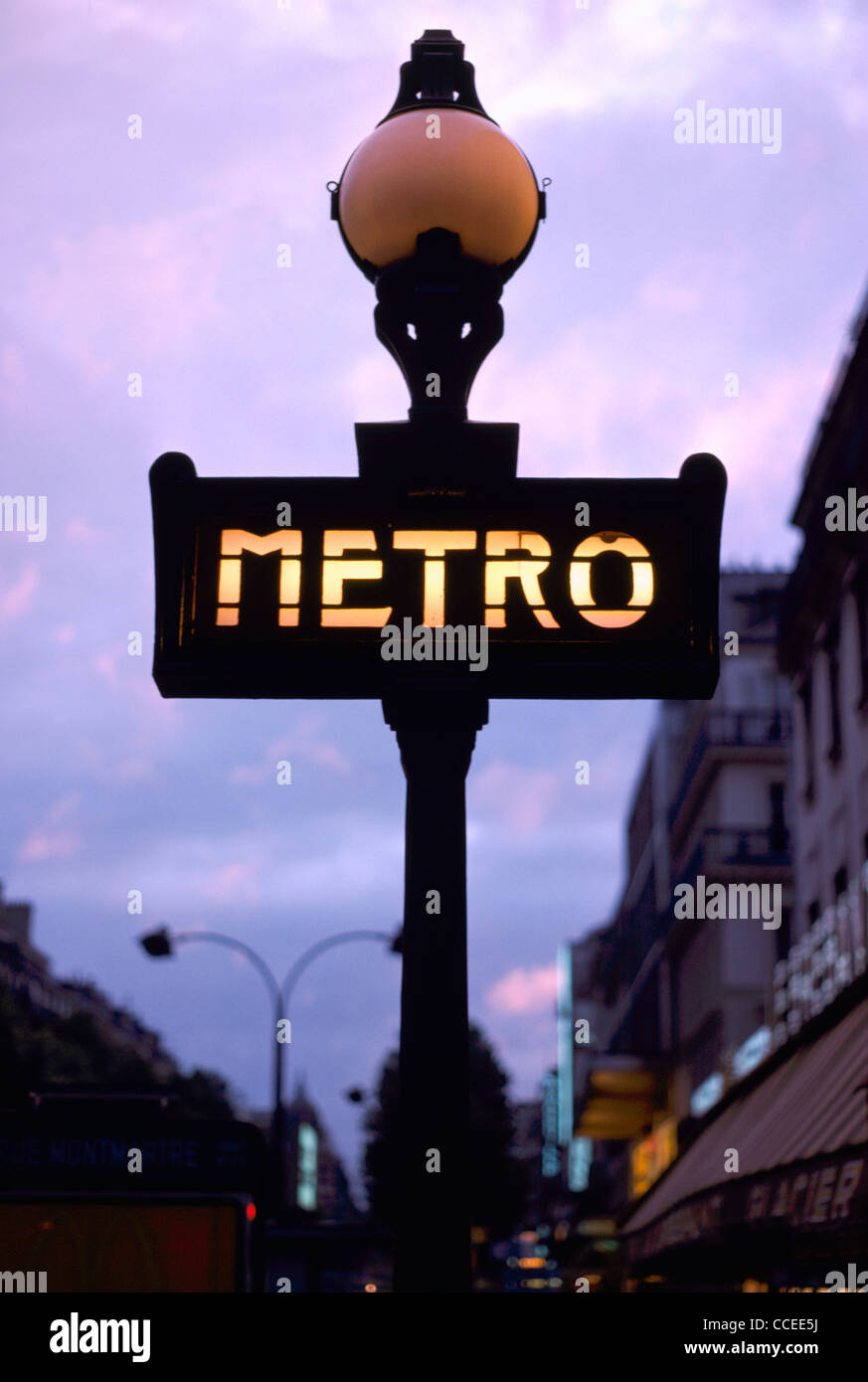An iconic Art-Nouveau illuminated sign outside Poissonniere Metro station, Paris, France, at dusk. Stock Photo