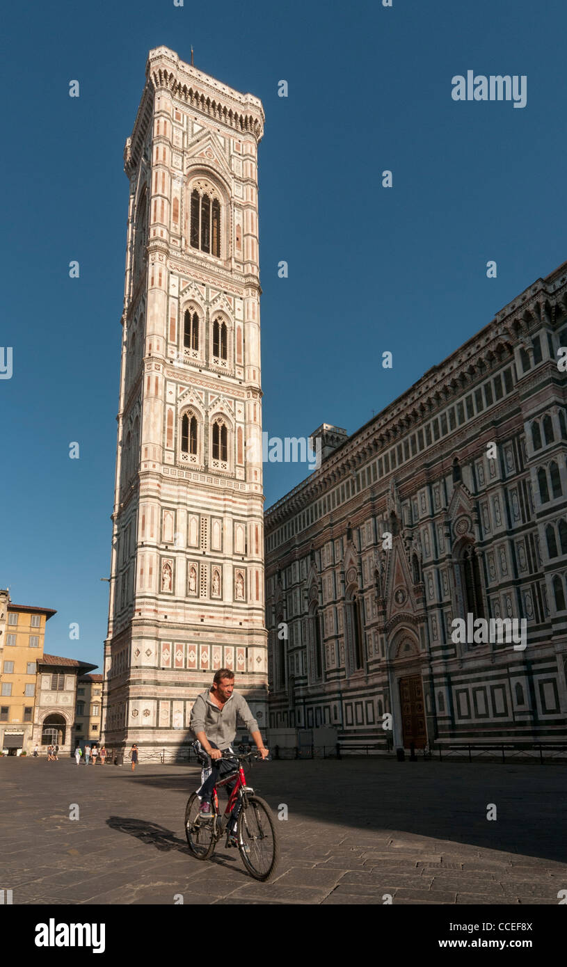 Cyclist in front of Giotto’s Campanile, Florence Cathedral (Duomo, Basilica di Santa Maria del Fiore), Firenze, Tuscany, Italy Stock Photo