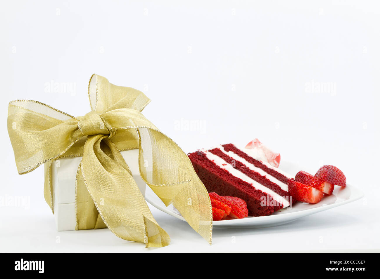White box wrapped with gold ribbon is a special gift placed next to a ...