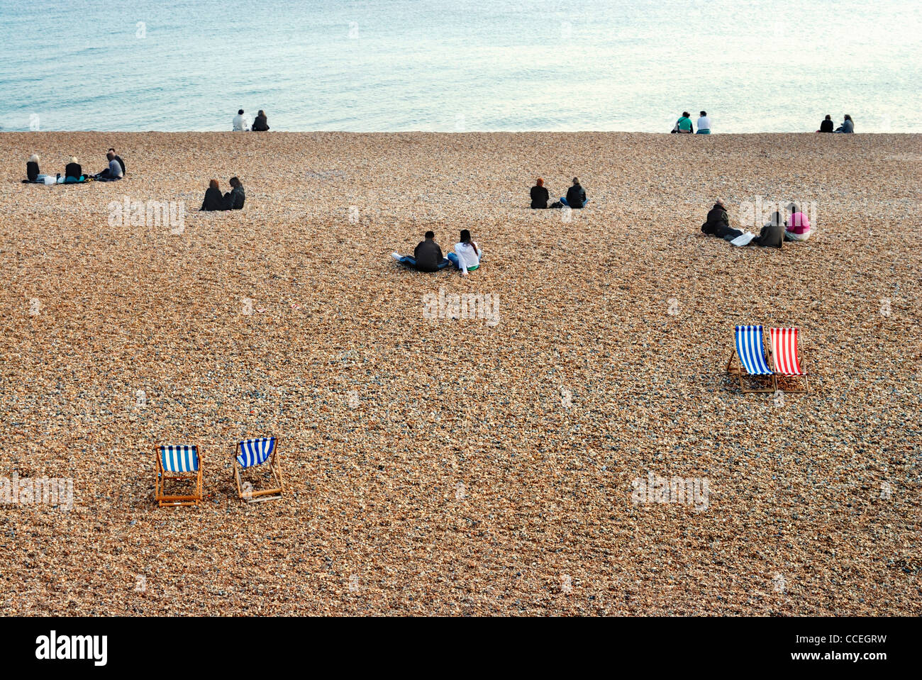 People and deckchairs, Brighton beach, Brighton, East sussex,england,uk Stock Photo