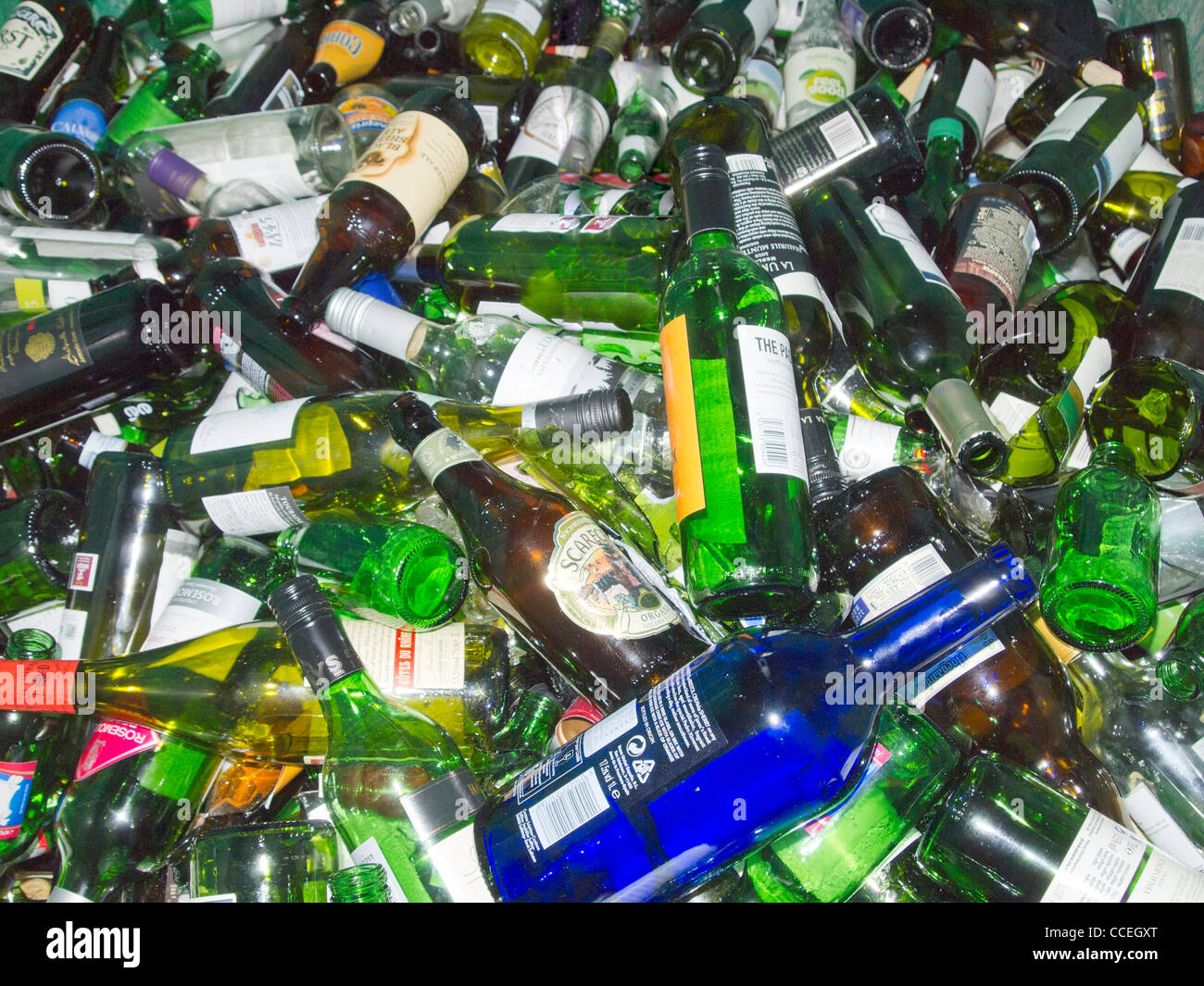 Many different coloured/colored glass wine and beer bottles heaped