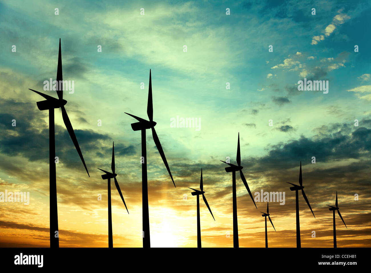 Wind turbines farm at sunset Stock Photo - Alamy