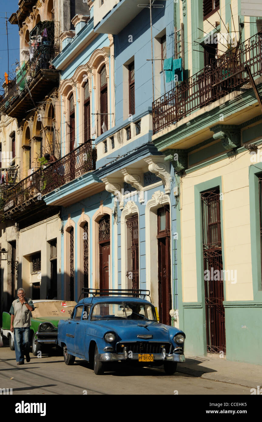 Old blue car, man smoking and colonial architecture, Havana,Cuba Stock Photo