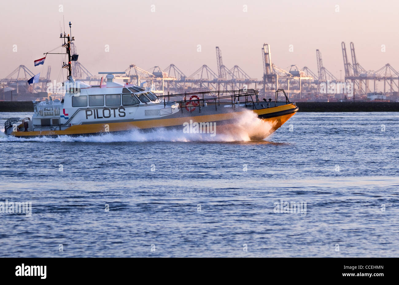 Pilot-boat passing by at high speed on the river in evening light - industry background Stock Photo