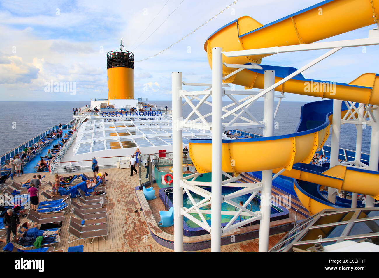 Costa Concordia cruise ship with passengers enjoying open deck with water slide and swimming pool on Mediterranean sea cruise 10 November 2011 Stock Photo