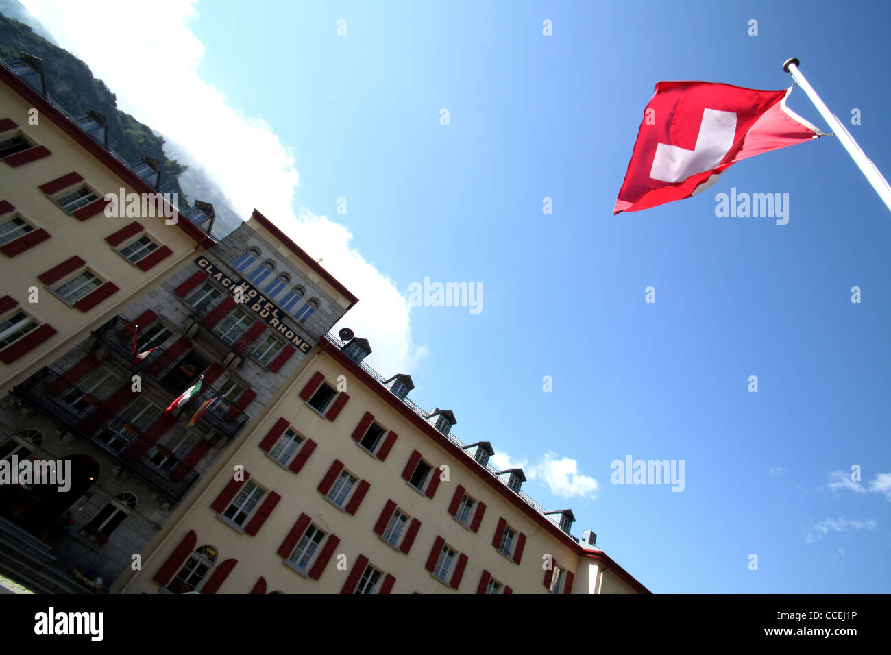 Hotel Glacier du Rhone with swiss flag in the alpine village of Gletsch, Furka, Valais, Alps, Switzerland, Europe Stock Photo