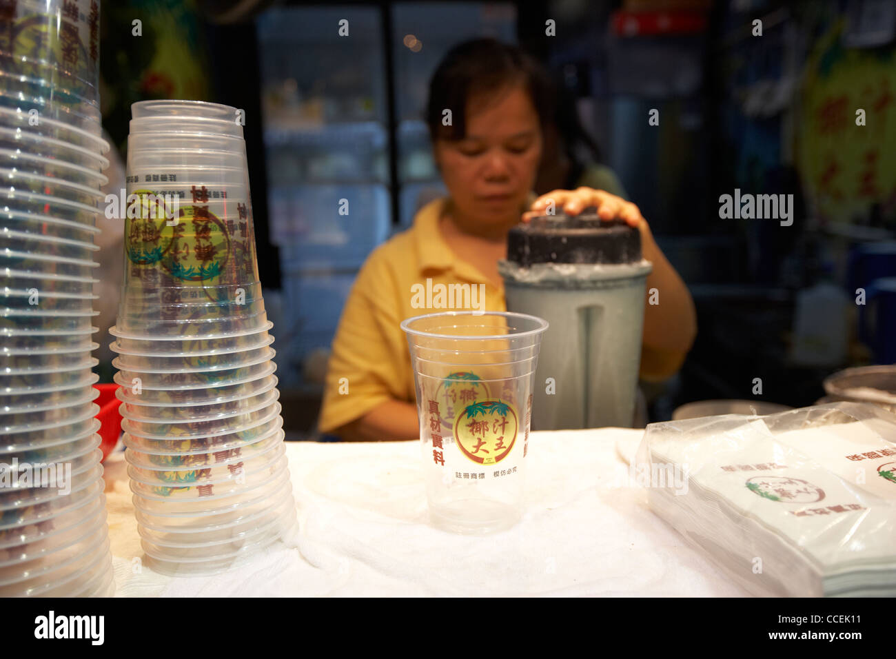 making a coconut milk drink at a stall in mong kok hong kong hksar
