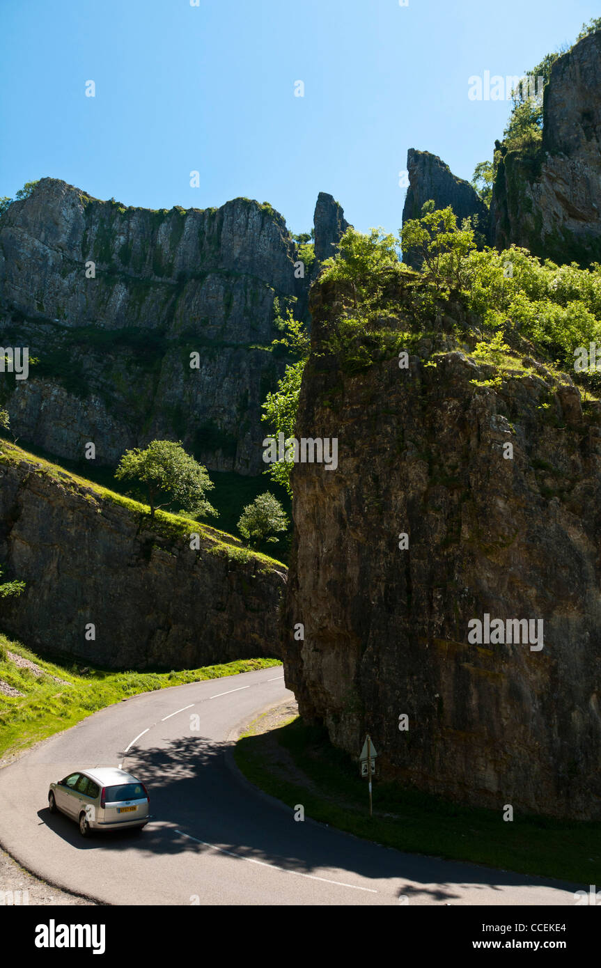 A motorcar driving through a sunny Cheddar Gorge in Somerset Stock Photo