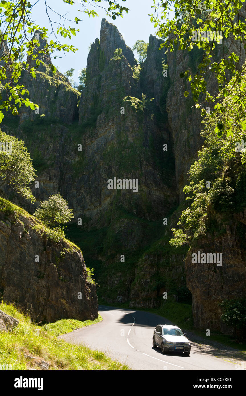 A motorcar driving through a sunny Cheddar Gorge in Somerset Stock Photo