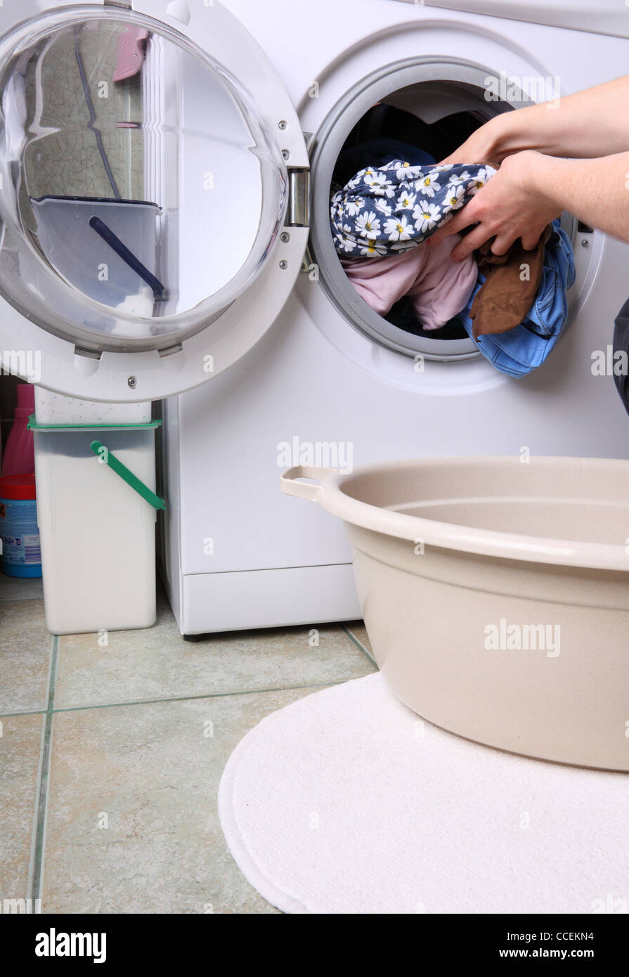 woman loading Preparation washing machine in bathroom clothes in the