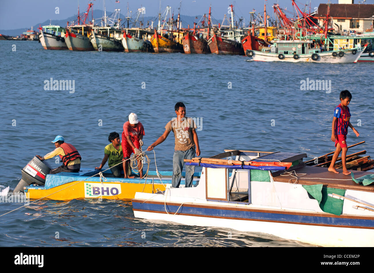 Wooden fishing boat fleet and water taxis on the waterfront in Kota Kinabalu, Borneo, Malaysia Stock Photo