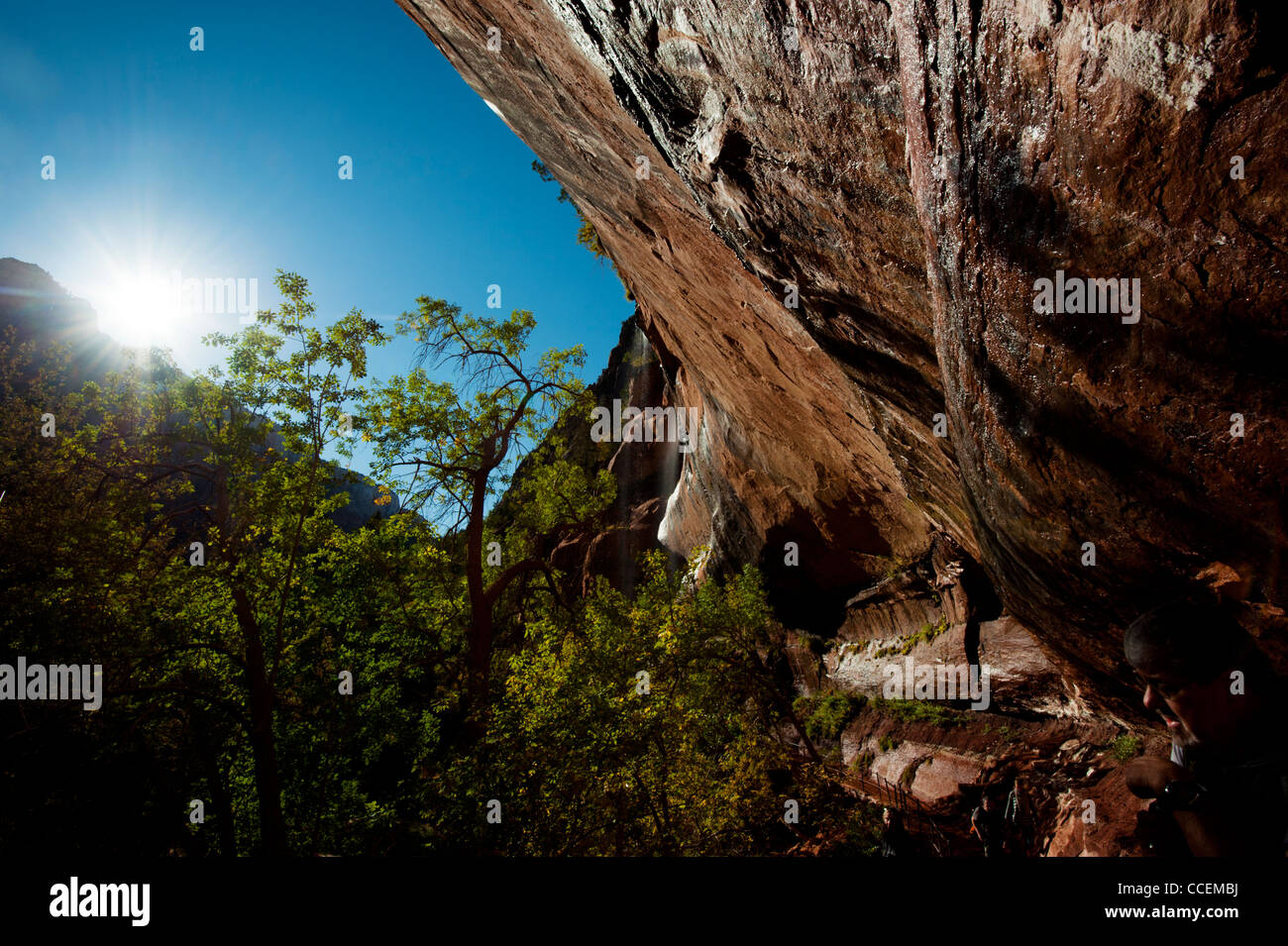 Eroded cliffs protruding out at a 30 degree angle backlit by the sun at ...