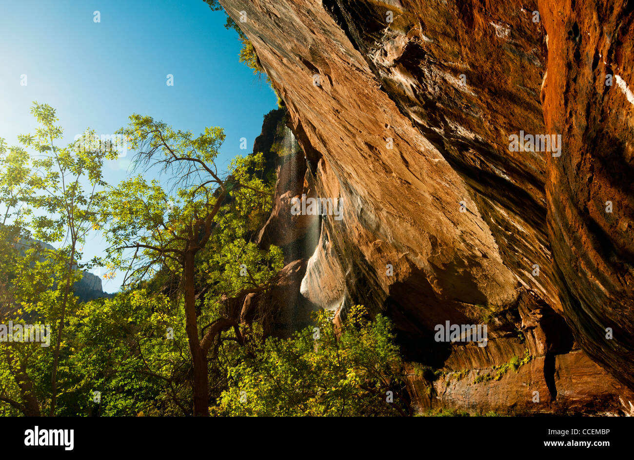 Eroded cliffs protruding out at a 30 degree angle backlit by the sun at ...