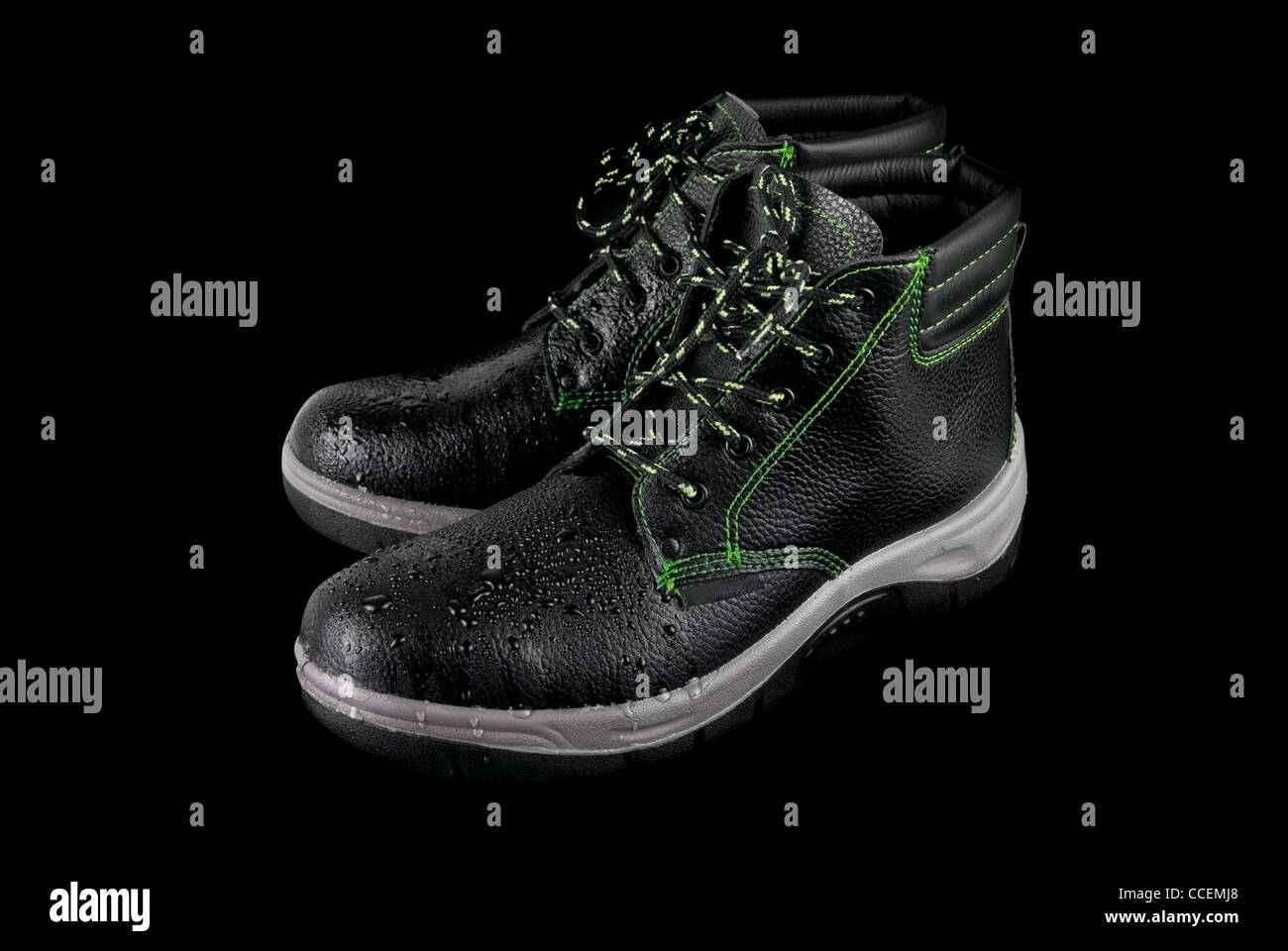 moist modern working boots isolated on a black background Stock Photo ...
