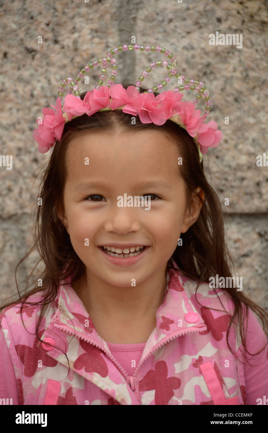 A beautiful young girl wearing a pink crown Stock Photo - Alamy