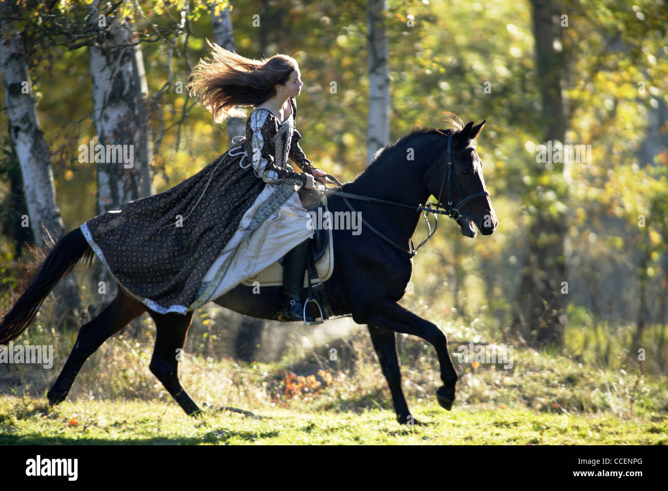 young woman in medieval dress on horseback Stock Photo