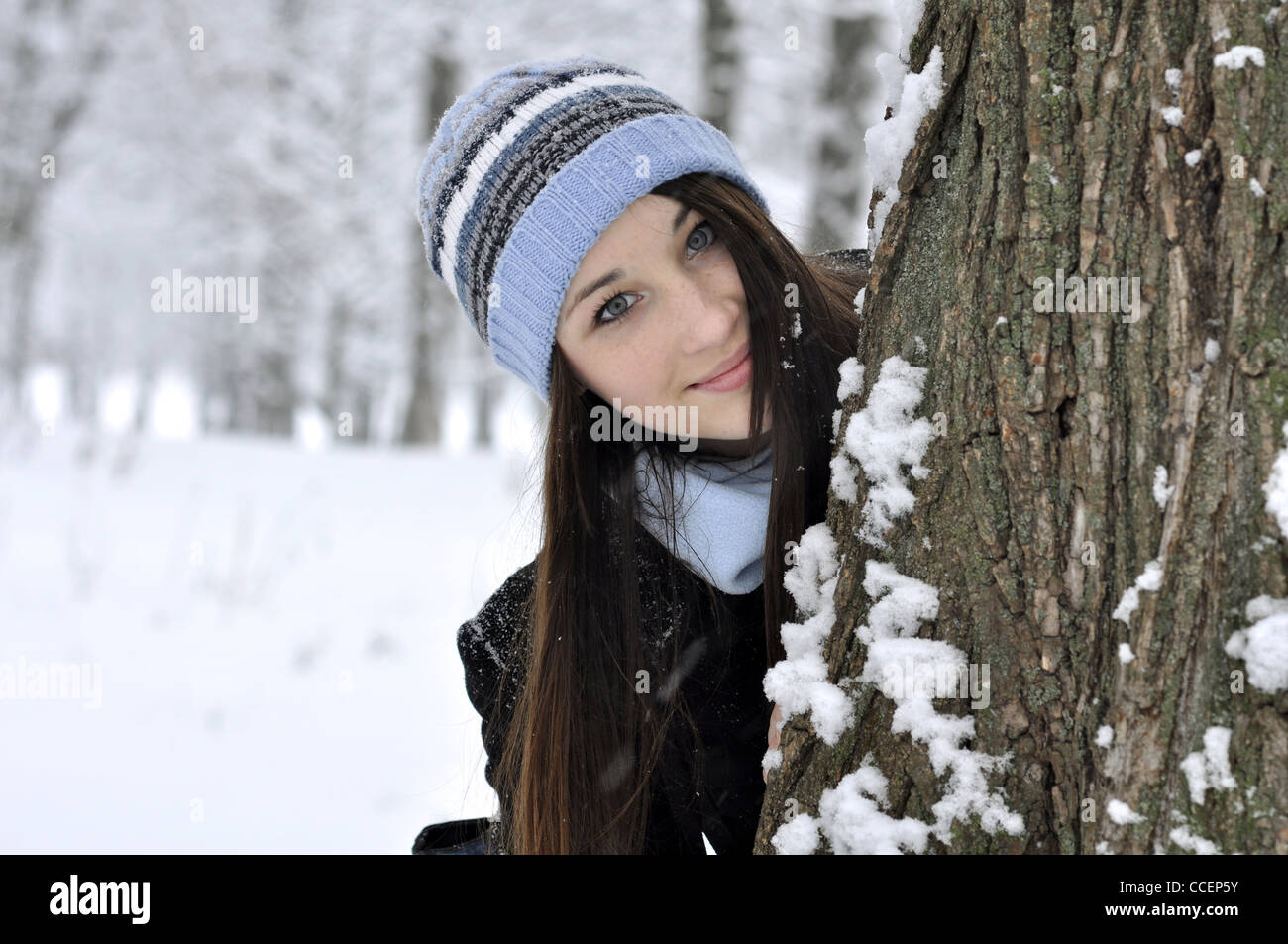 Beautiful young girl in snowy winter park Stock Photo - Alamy