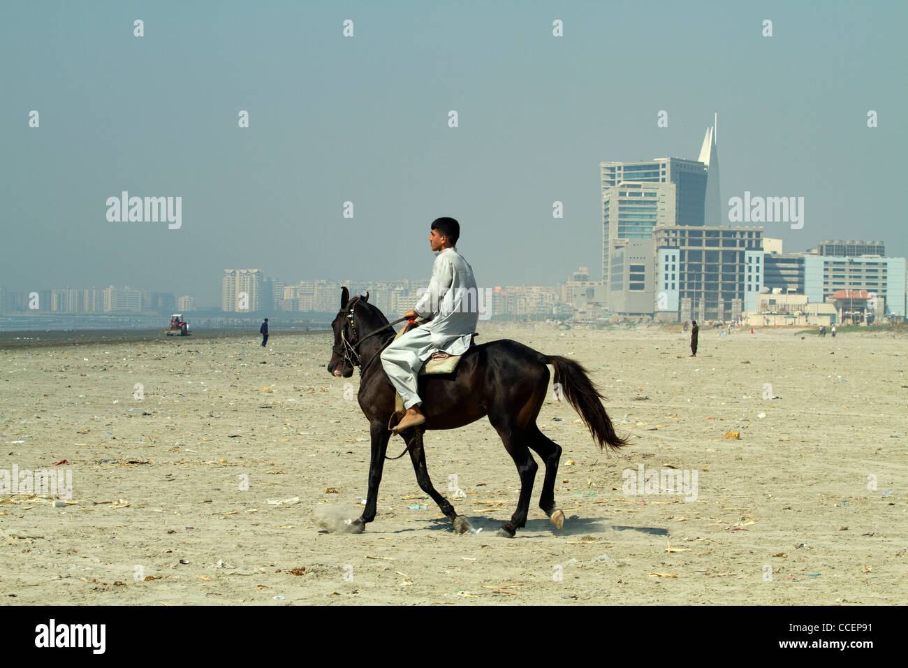 Man horse riding on Karachi beach Pakistan Stock Photo Alamy