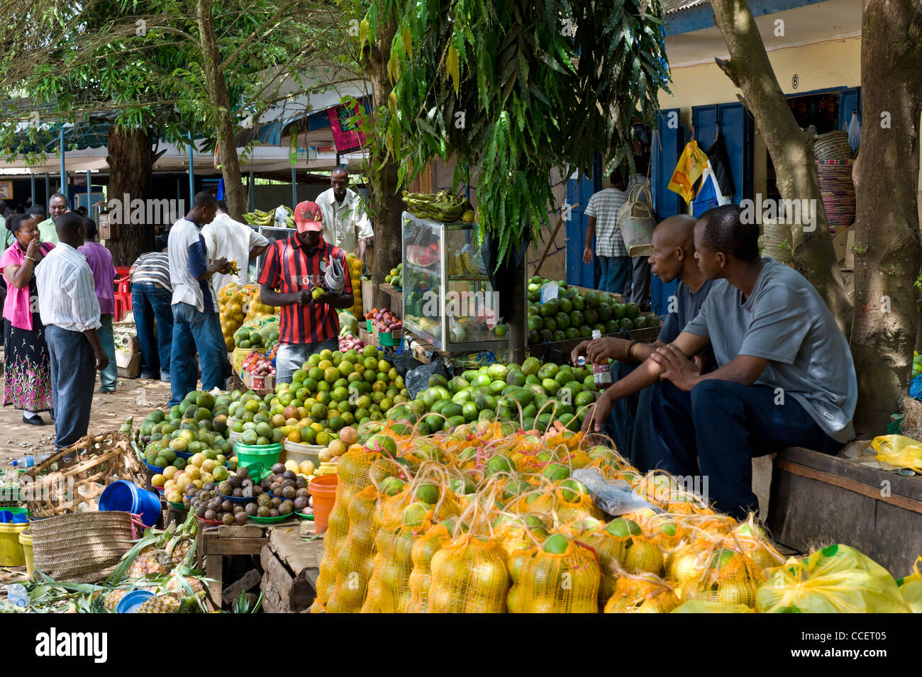 Fruit stand and passengers at Korogwe bus stand Tanga Region Tanzania Stock Photo