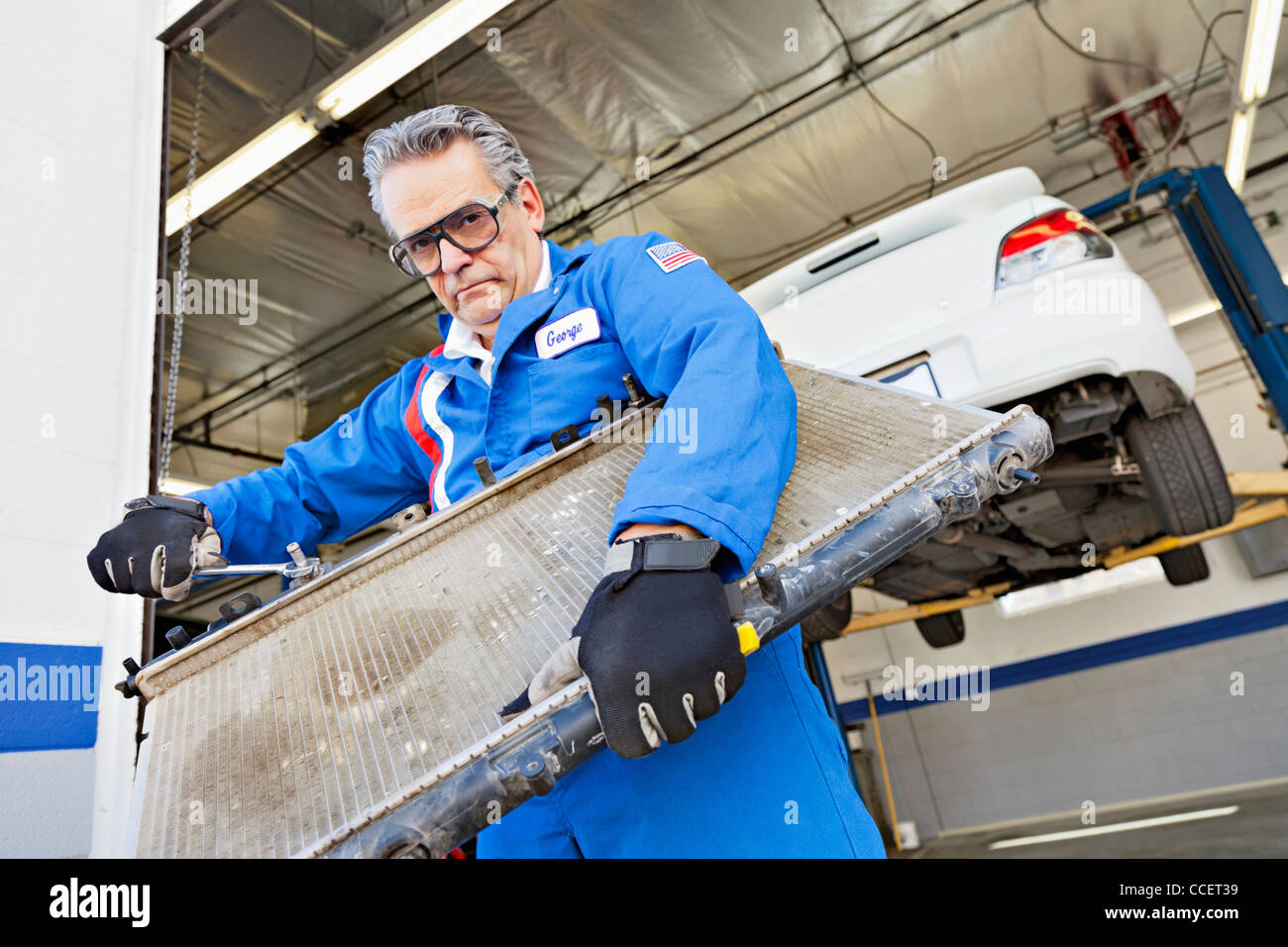 Portrait of mechanic working on an auto part Stock Photo