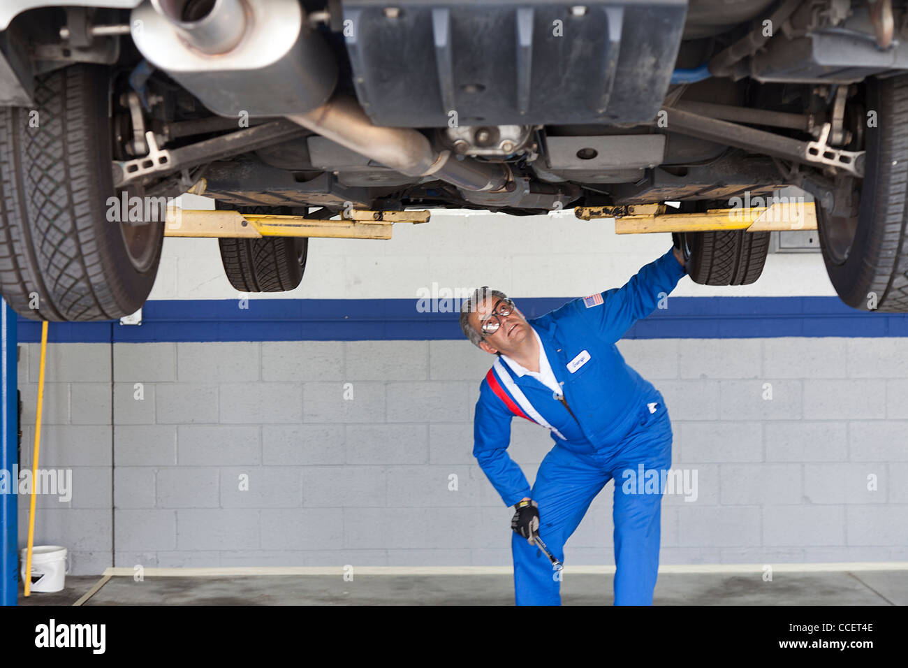 Mechanic checking the car at automobile repair shop Stock Photo