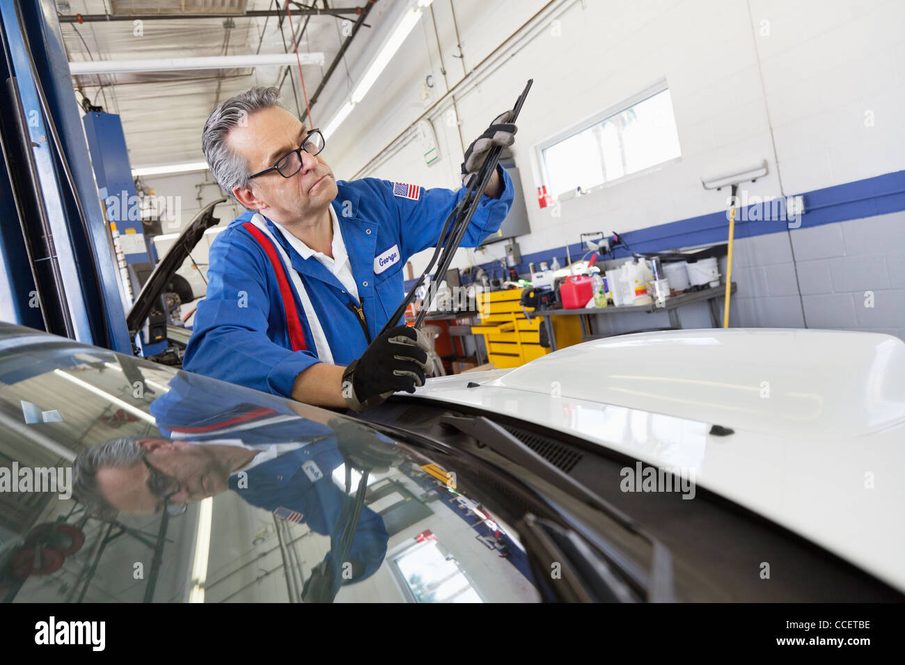Senior mechanic working on windshield wipers Stock Photo