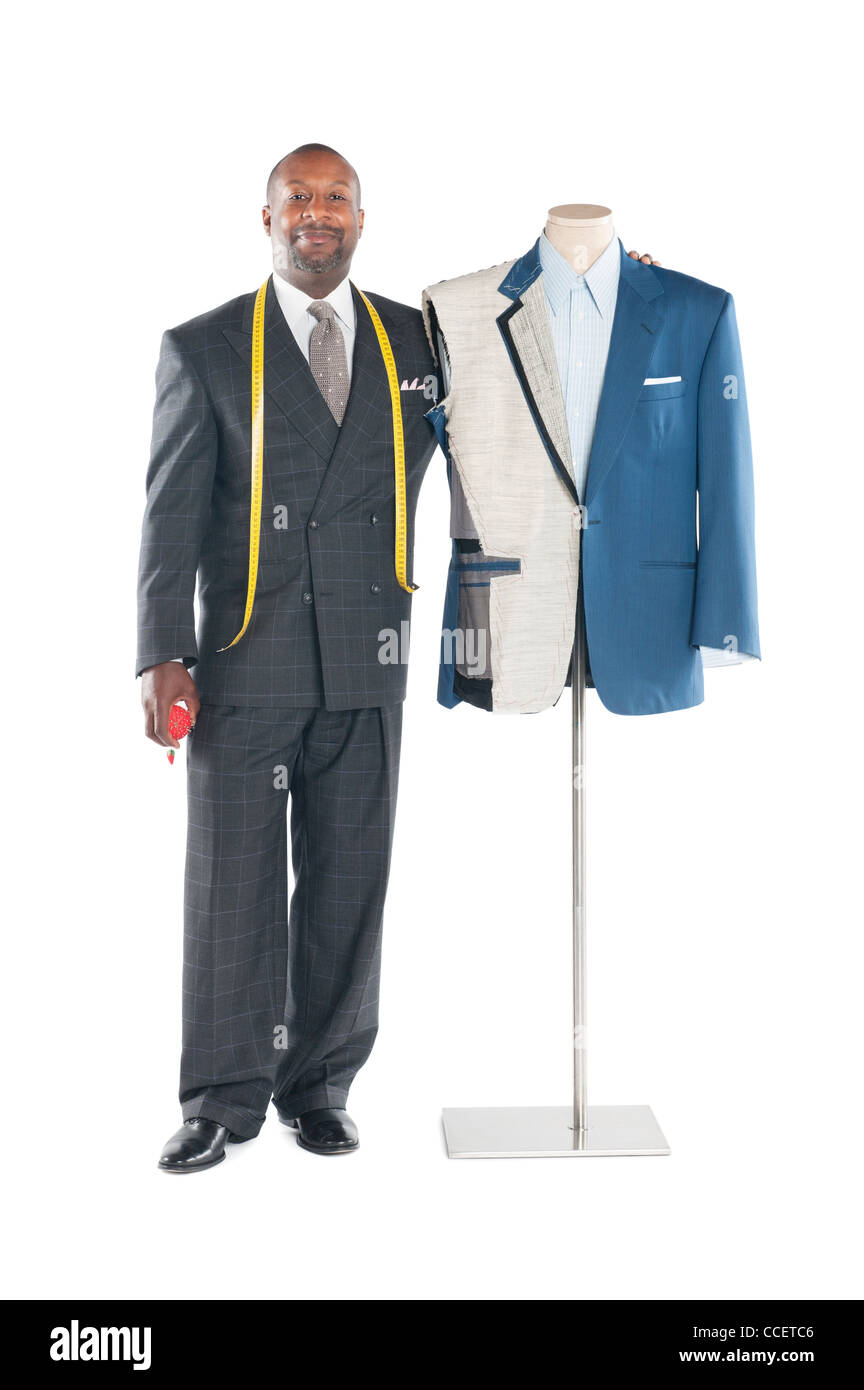 Portrait of a male tailor standing next to a mannequin Stock Photo