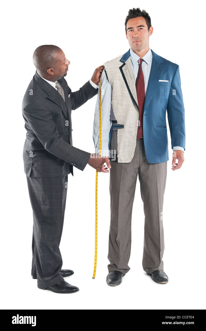 Man getting measured by a tailor on a white background Stock Photo
