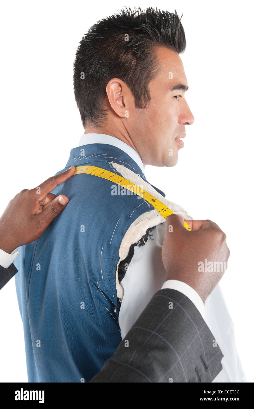 Profile view of man getting measured by tailor Stock Photo