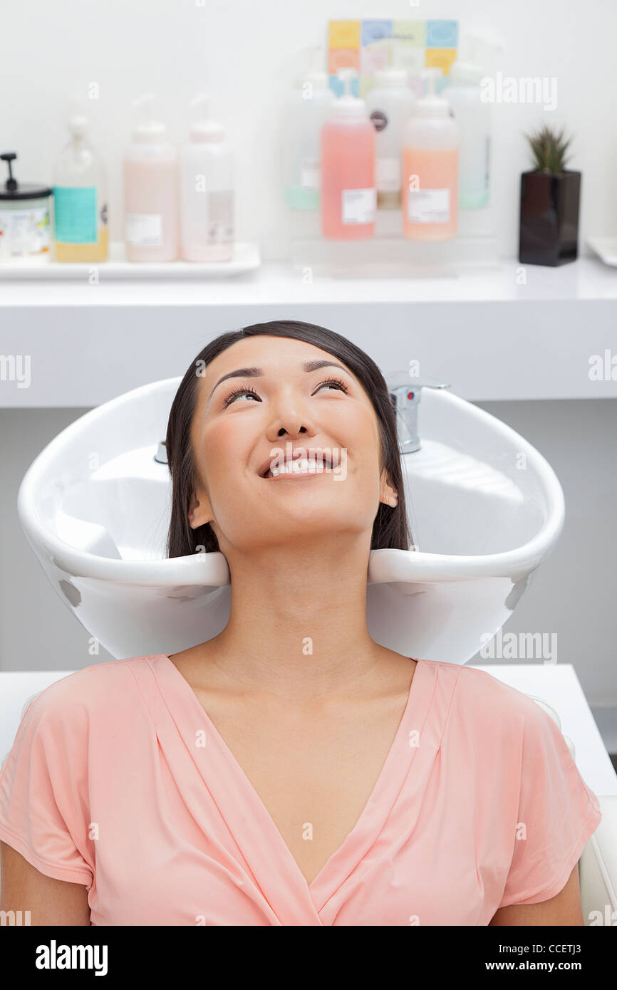 Woman getting her hair washed at beauty salon Stock Photo