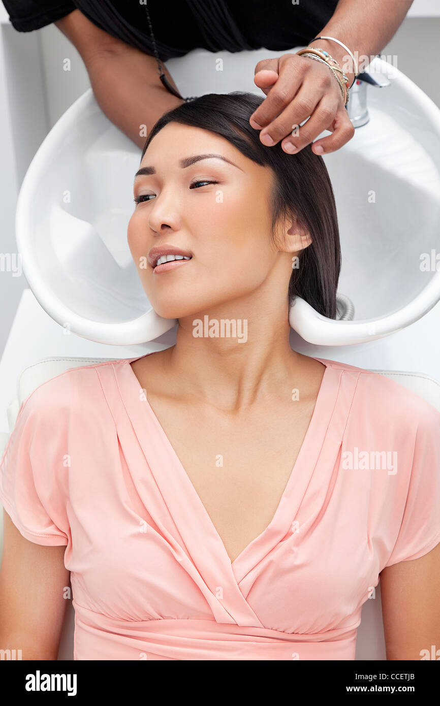 Asian woman having hair wash at beauty salon Stock Photo