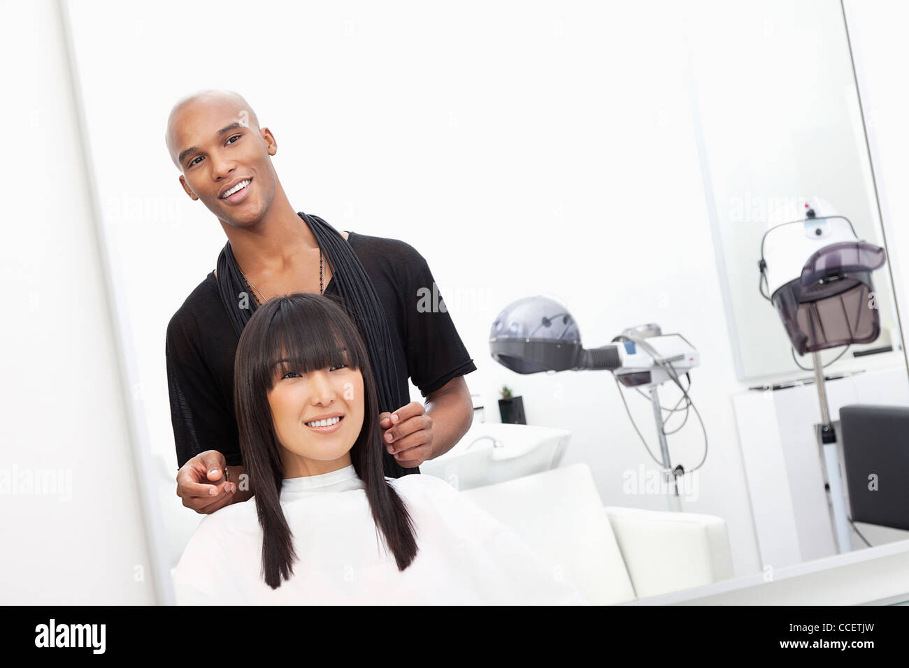 Hairstylist with female customer at beauty salon Stock Photo