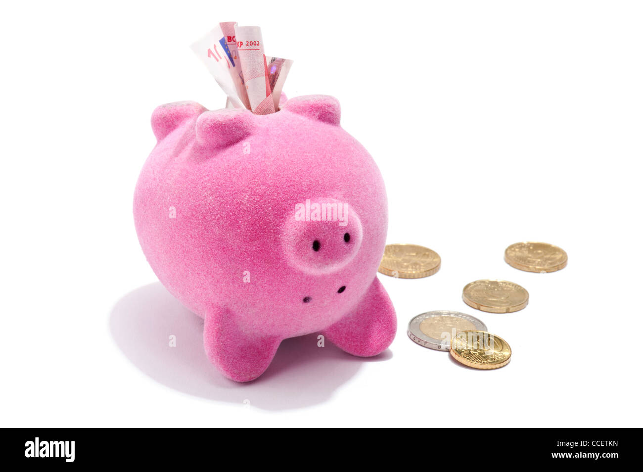 Euro bank notes and coins being removed from a piggy bank Stock Photo