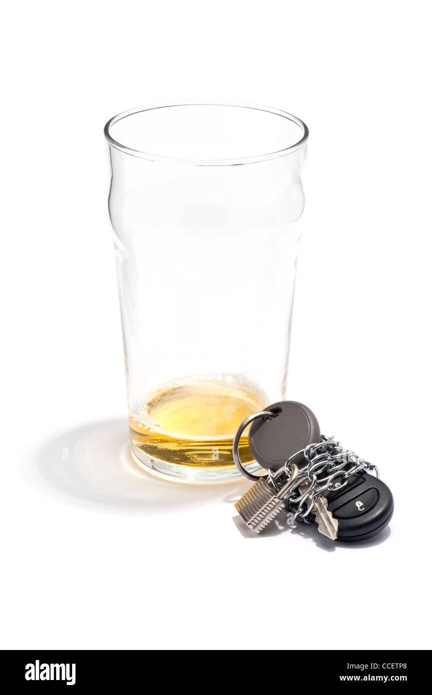 An empty pint of beer and a car key chained and padlocked Stock Photo