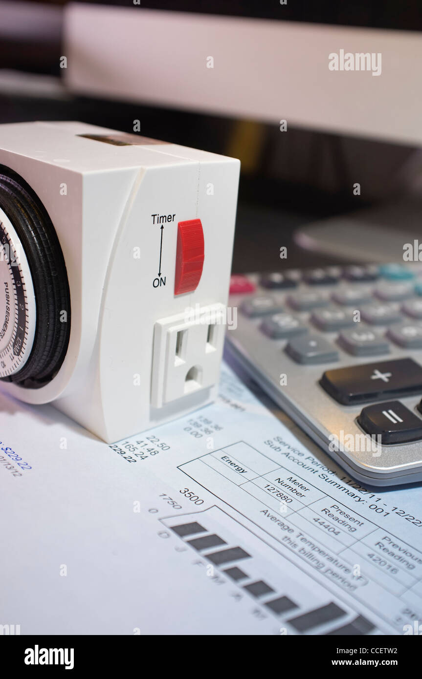Electricity Bill With Manual Timer And Calculator At A Home Office