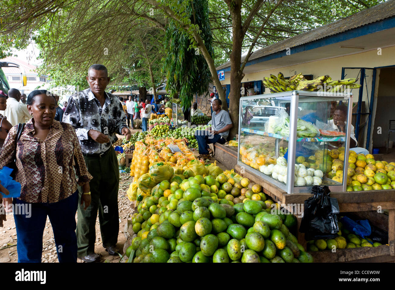 Fruit stand and passengers at Korogwe bus stand Tanga Region Tanzania Stock Photo
