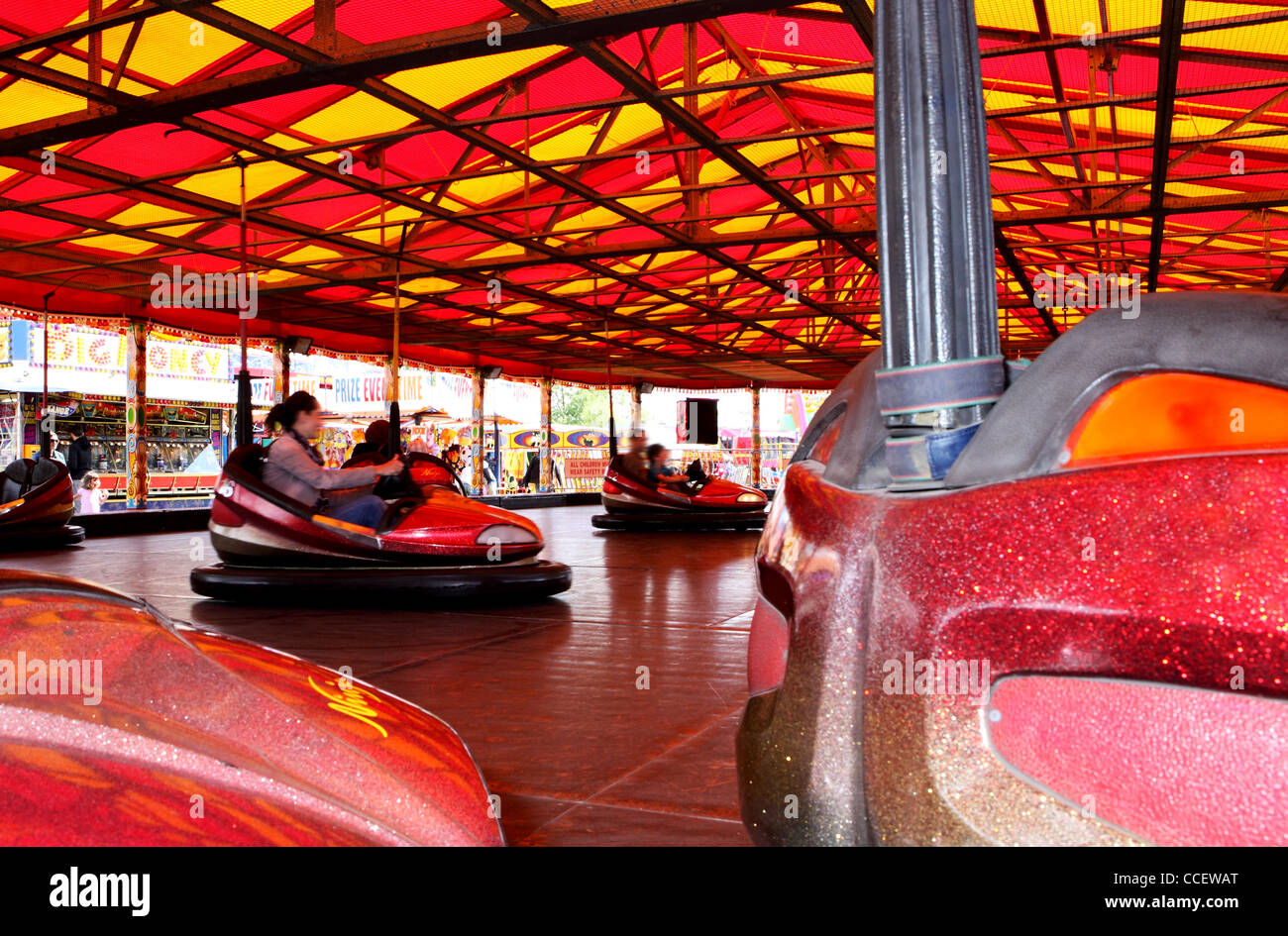 People riding in bumper cars Stock Photo