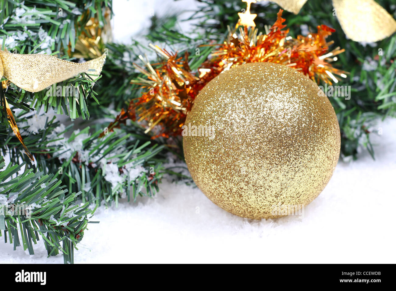 Christmas ball on firtree branch in snow Stock Photo - Alamy