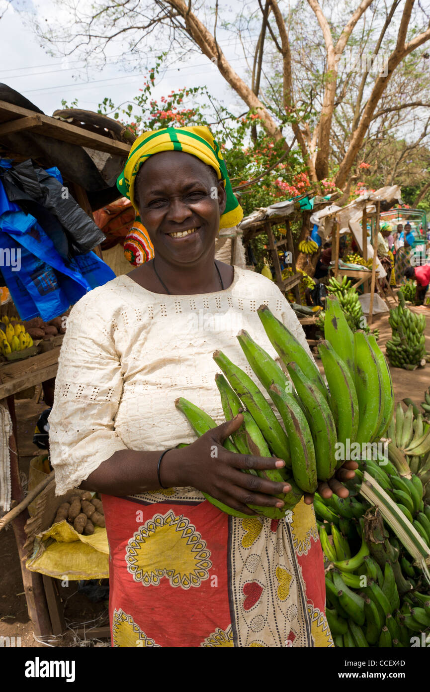 A woman sells cooking banana along a road in Moshi Kilimanjaro Region Tanzania Stock Photo