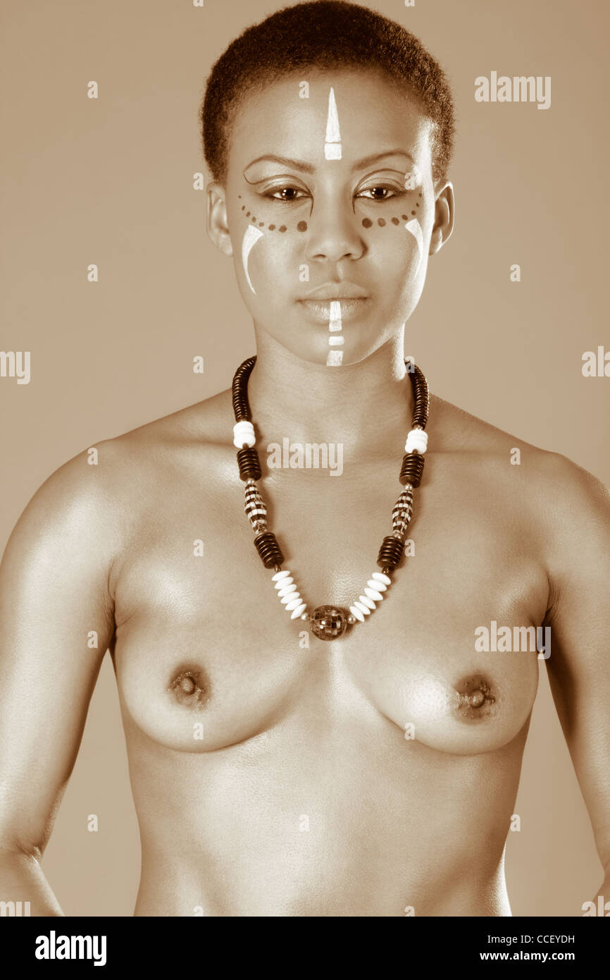 Portrait of topless African American woman wearing original tribal themed face-paint and necklace Stock Photo