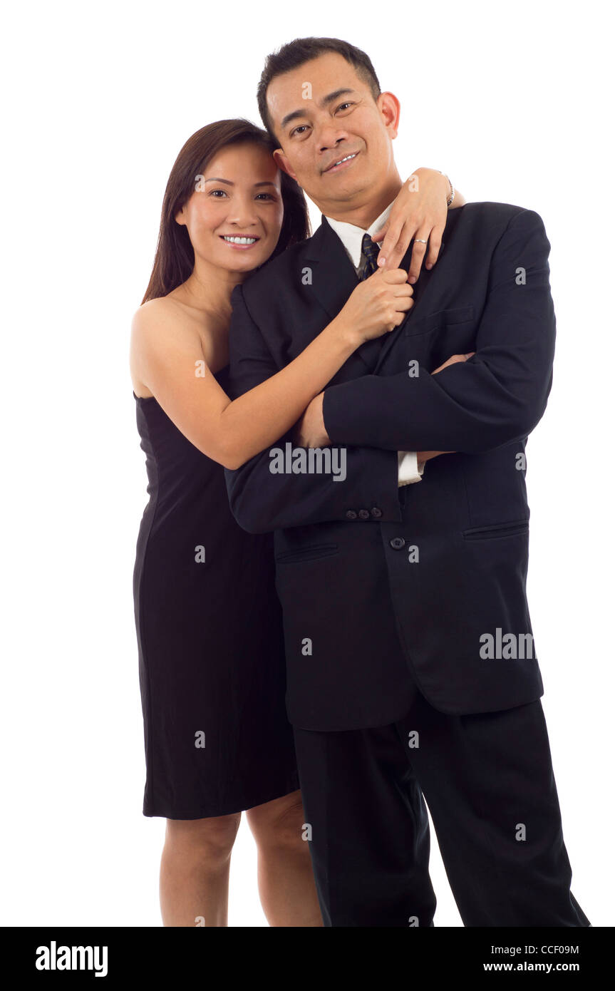 Happy Asian couple standing together isolated over white background ...