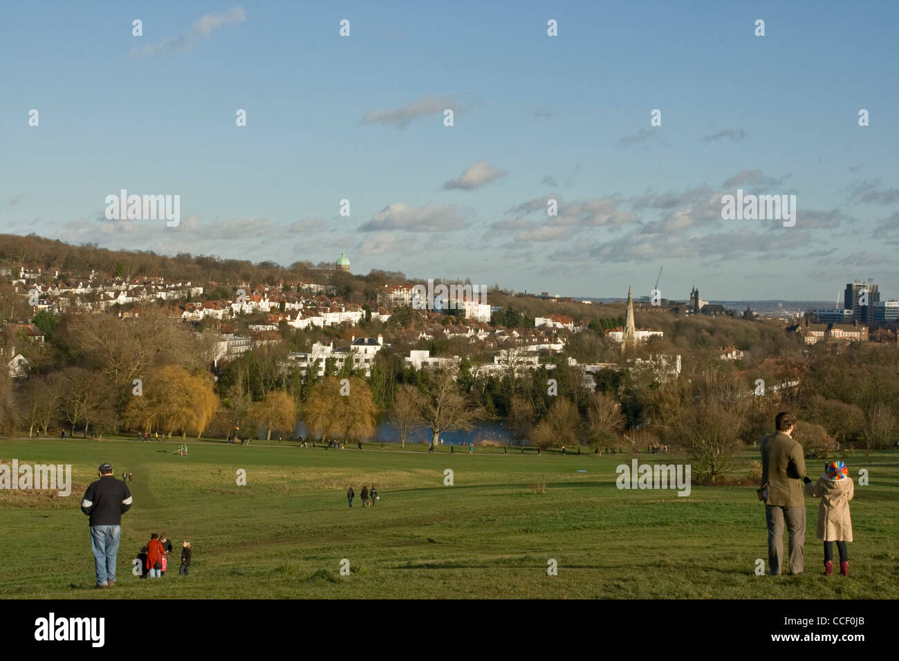 People enjoying leisure time on Hampstead Heath in winter sun London England Europe Stock Photo
